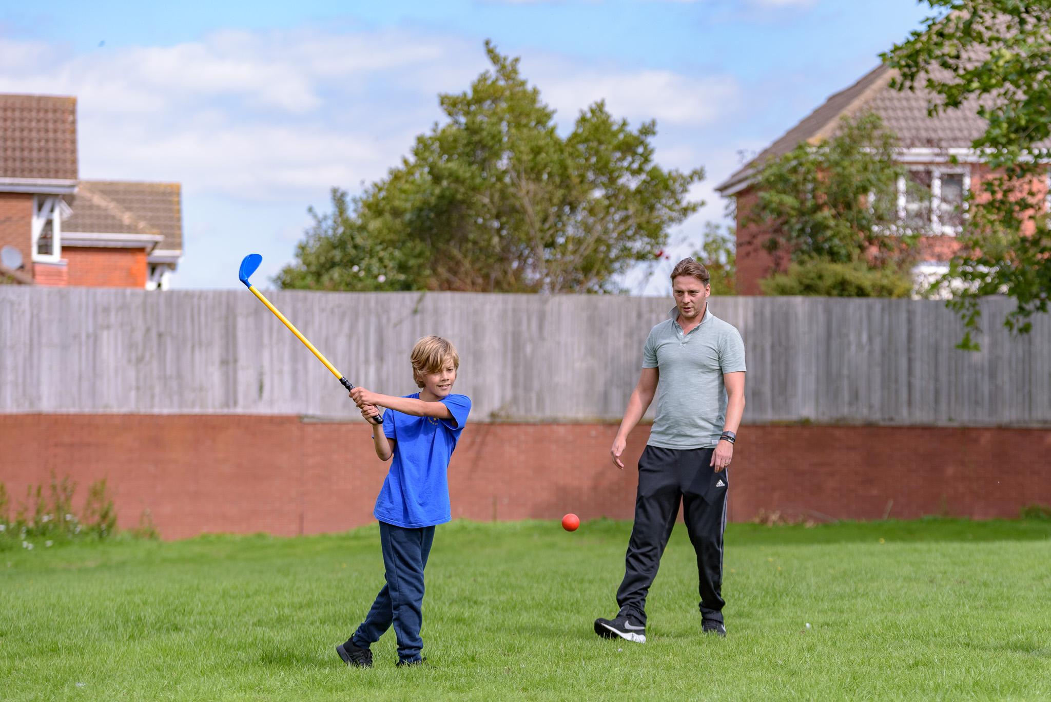 Teacher and pupil learning golf